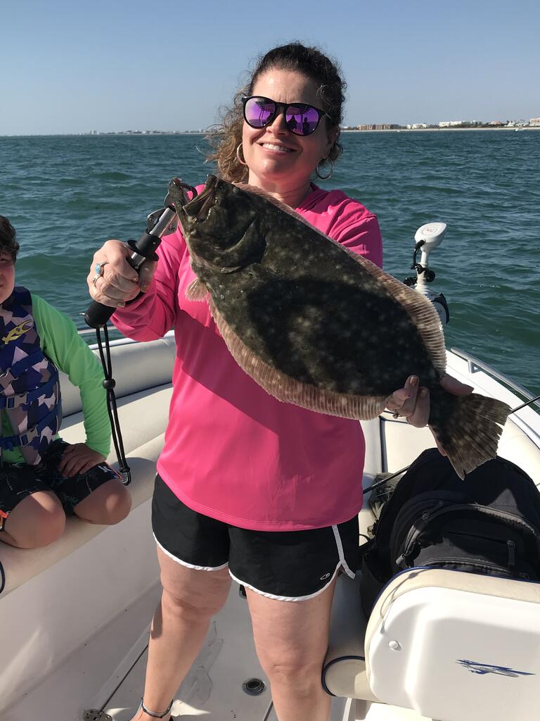 Woman holding up her catch
